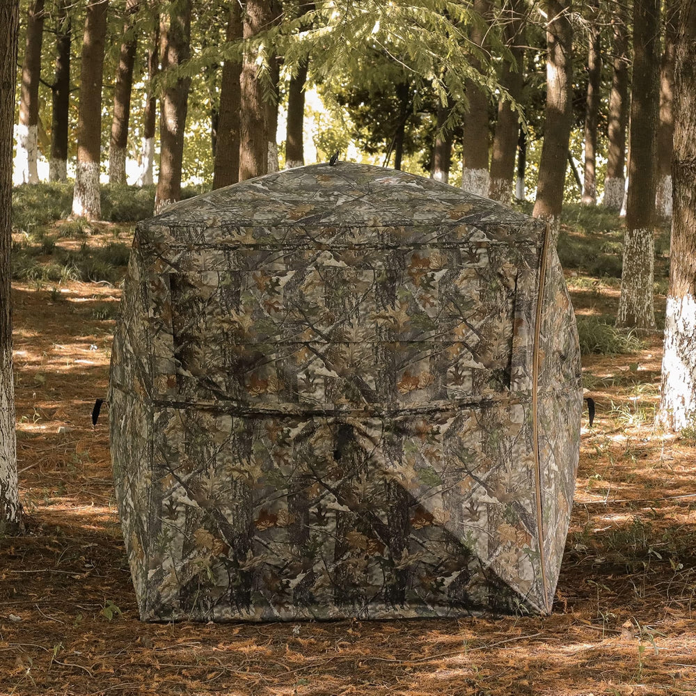 LENOTOS A-1013 camouflage hunting blind set up among trees in the woods