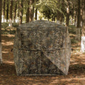 LENOTOS A-1013 camouflage hunting blind set up among trees in the woods